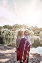 Happy, girl huggs her beautiful mother near lake