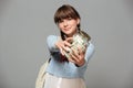 Happy girl isolated grey background with jar full of money Royalty Free Stock Photo