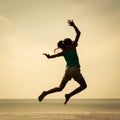Happy girl jumping on the beach on the day time Royalty Free Stock Photo