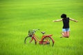 Happy girl jumping in green field