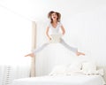 Happy girl jumping and having fun in bed Royalty Free Stock Photo