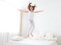 Happy girl jumping and having fun in bed Royalty Free Stock Photo