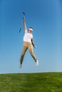 Happy girl jumping high on golf course Royalty Free Stock Photo