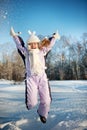 Happy girl jumping in the snow Royalty Free Stock Photo