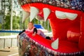 A happy girl jumps on a street inflatable trampoline in the shape of a dragon.