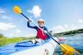 Happy girl kayaking on the river on a sunny day during summer vacation Royalty Free Stock Photo