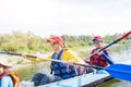 Happy girl kayaking on the river on a sunny day during summer vacation Royalty Free Stock Photo