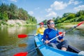 Happy girl kayaking on the river on a sunny day during summer vacation Royalty Free Stock Photo