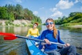 Happy girl kayaking on the river on a sunny day during summer vacation Royalty Free Stock Photo