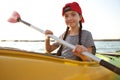 Happy little girl kayaking on river. Summer camp activity Royalty Free Stock Photo