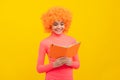 Happy girl kid with orange hair in pink poloneck smile reading school book, knowledge Royalty Free Stock Photo