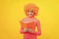 Happy girl kid with orange hair in pink poloneck smile reading school book, knowledge Royalty Free Stock Photo