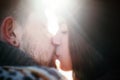 Happy girl kiss boyfriend with a red beard against sunshine Royalty Free Stock Photo