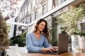 Happy girl with laptop is chatting with her friends and family outdoor in cafe. Confident business woman is chatting Royalty Free Stock Photo