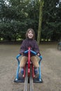 Happy girl laughing and swinging on a pendulum