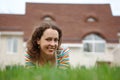 Happy girl on lawn in front of new home Royalty Free Stock Photo