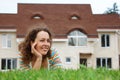 Happy girl on lawn in front of new home Royalty Free Stock Photo