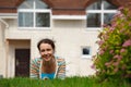 Happy girl on lawn in front of new home Royalty Free Stock Photo