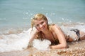 Happy girl laying on beach in water drops Royalty Free Stock Photo