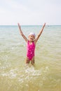 Happy girl let up splashes water standing Royalty Free Stock Photo