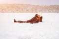 happy girl lies in the snow, laughing and having fun. Artistically colored photo