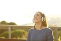 Happy girl listening music on headphones at sunset Royalty Free Stock Photo