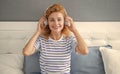 Happy girl listening to music on bed, leisure. Woman enjoying leisure pastime at home Royalty Free Stock Photo