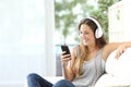 Happy girl listening to music from mobile phone Royalty Free Stock Photo