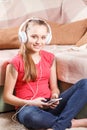 Happy girl listening to the music from smartphone Royalty Free Stock Photo