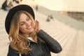 Happy girl with long blond hair, hairstyle, in paris, france. Girl in black hat smile outdoor, fashion. Beauty, look Royalty Free Stock Photo