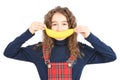 Happy girl with long curly hair making banana smile isolated on white background