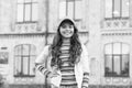 Happy girl with long curly hair. pretty child smiling outdoor. kid beauty and fashion. cheerful school girl wear cap Royalty Free Stock Photo