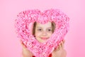 Happy girl looking through rosy heart on pink background Royalty Free Stock Photo