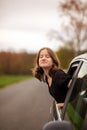 happy girl looks out of the car window closing her eyes on a summer day Royalty Free Stock Photo