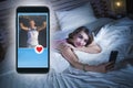 Happy girl lying on bed smiling and flirting on internet social media app using mobile phone watching guys profiles sending likes Royalty Free Stock Photo