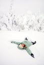 Happy girl lying down on snow Royalty Free Stock Photo