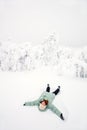 Happy girl lying down on snow Royalty Free Stock Photo