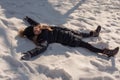 Happy girl lying down on the snow in winter. The girl lies in the snow in winter Royalty Free Stock Photo