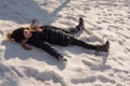 Happy girl lying down on the snow in winter. The girl lies in the snow in winter Royalty Free Stock Photo