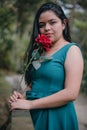 Happy girl in the middle of a bridge with rose in hands