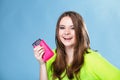 Happy girl with mobile phone in pink cover Royalty Free Stock Photo