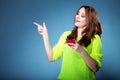Happy girl with mobile phone pointing Royalty Free Stock Photo