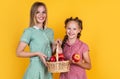 happy girl and mother holding apples from garden. kid hold basket with fruit. mom and child eating apple. summer healthy Royalty Free Stock Photo