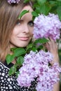 Happy girl near lilac tree in sity park Royalty Free Stock Photo