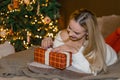 Happy girl opening Christmas presents at home photo Royalty Free Stock Photo