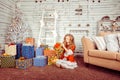 Happy girl opening gift box isolated room Christmas decorated. Winter holidays concept Royalty Free Stock Photo