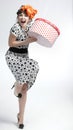 Happy girl opening gift box with red polka dots Royalty Free Stock Photo