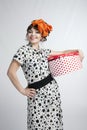 Happy girl opening gift box with red polka dots Royalty Free Stock Photo