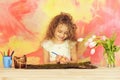 Happy girl painter with pencil, easter egg and tulip flowers Royalty Free Stock Photo