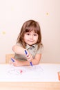 Happy girl painting a bug with marker